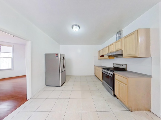 kitchen featuring light brown cabinetry, range with electric stovetop, freestanding refrigerator, and under cabinet range hood