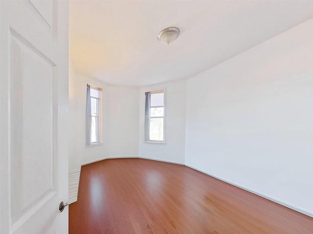 unfurnished room with wood finished floors