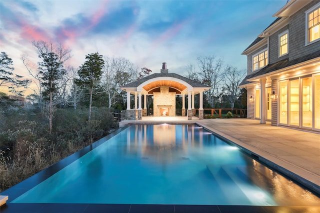 view of pool with a patio area and a fireplace