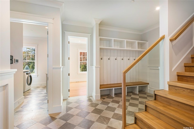 mudroom featuring baseboards, washer / dryer, and ornamental molding