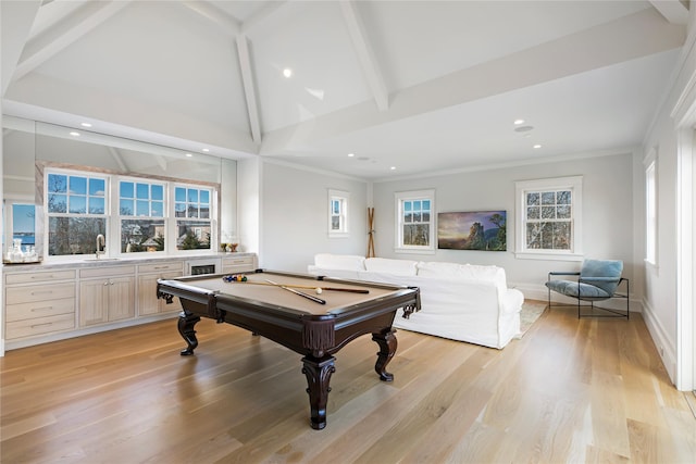 playroom with a sink, beam ceiling, light wood-style floors, and crown molding