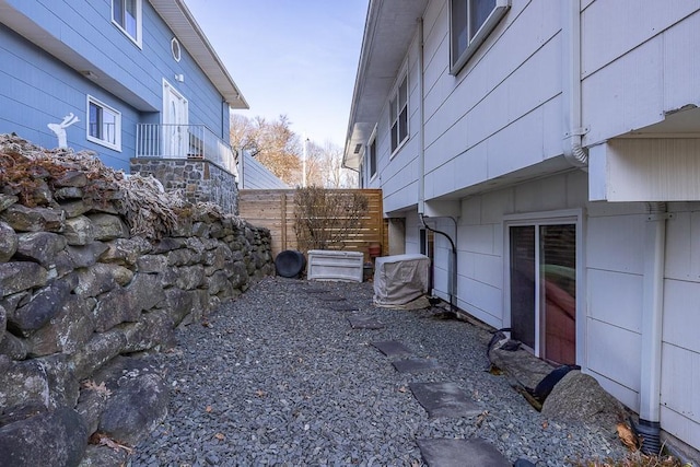 view of side of home featuring stairway