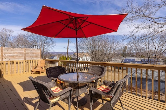 wooden deck featuring outdoor dining area