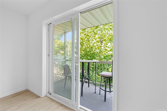 entryway with baseboards and wood finished floors