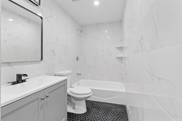 bathroom featuring shower / tub combination, tile walls, toilet, and vanity