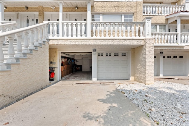 garage featuring concrete driveway