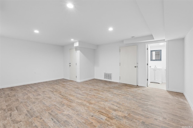 unfurnished room with light wood-type flooring, visible vents, baseboards, and recessed lighting