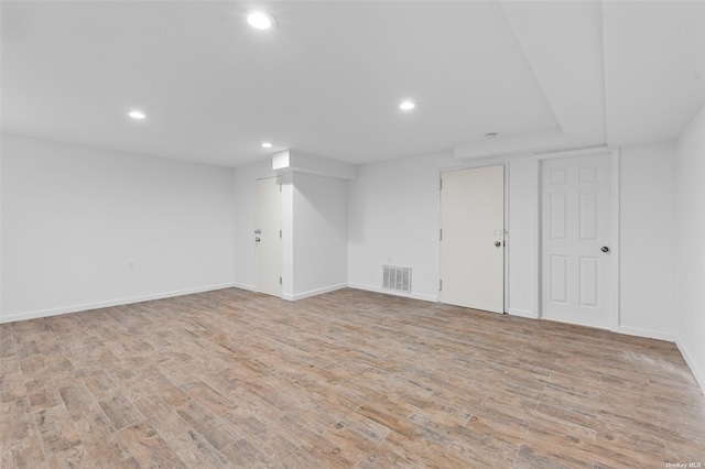 unfurnished room featuring baseboards, recessed lighting, visible vents, and light wood-style floors