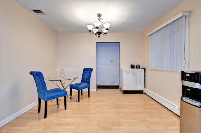 dining space featuring an inviting chandelier, baseboards, visible vents, and wood finished floors