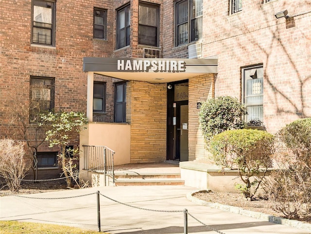 entrance to property featuring brick siding