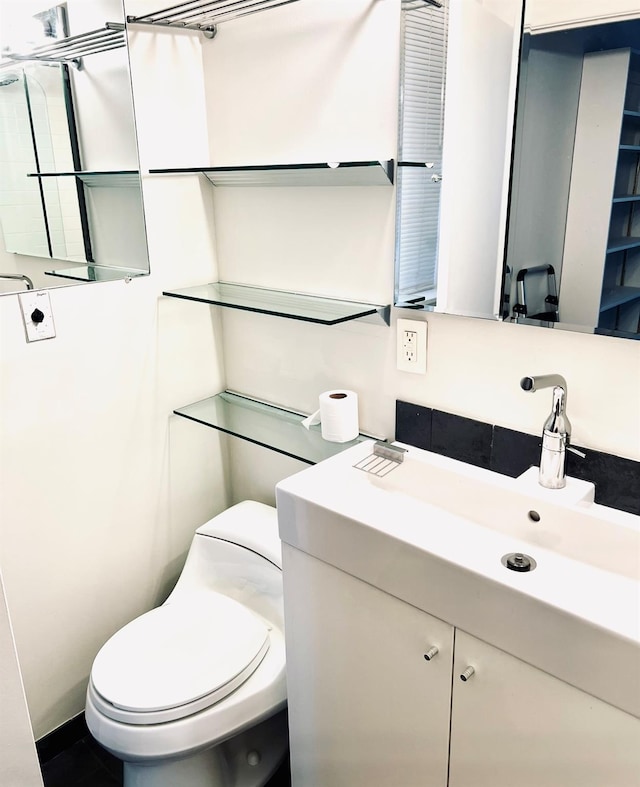 bathroom featuring vanity and toilet