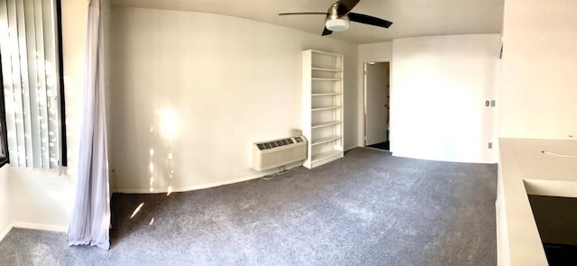 spare room featuring carpet floors, a ceiling fan, and a wall mounted air conditioner