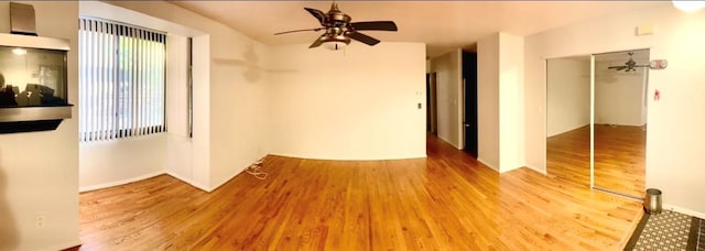 unfurnished room featuring a ceiling fan and wood finished floors