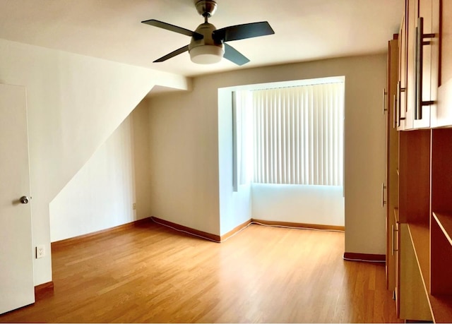 bonus room featuring a ceiling fan, baseboards, and wood finished floors