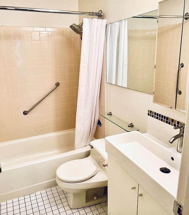 full bathroom featuring toilet, vanity, shower / tub combo with curtain, and tile patterned floors