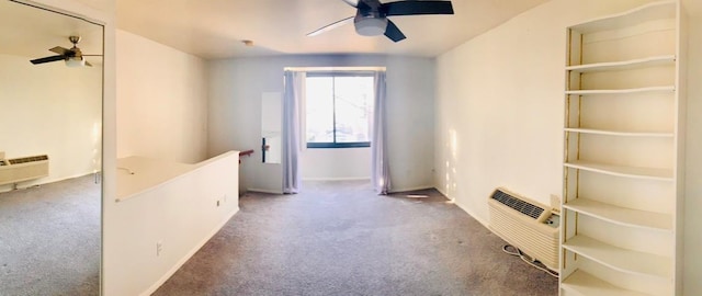 interior space featuring carpet, baseboards, a ceiling fan, and a wall mounted air conditioner