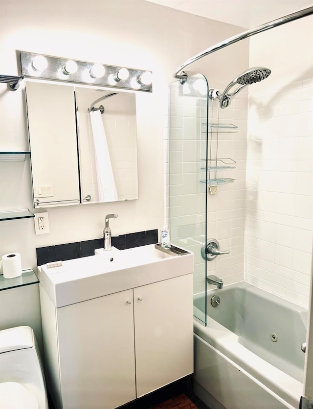 bathroom featuring toilet, shower / bathtub combination with curtain, and vanity