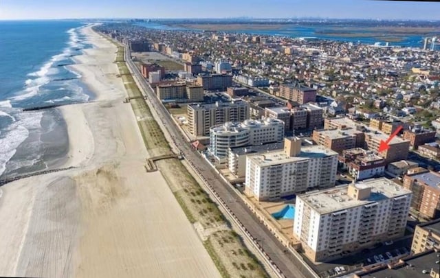 aerial view with a view of the beach, a water view, and a view of city