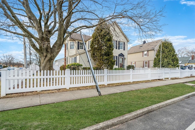 view of front facade with a fenced front yard and a residential view