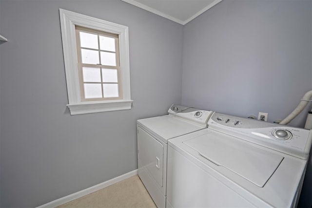 laundry area featuring laundry area, ornamental molding, washer and clothes dryer, and baseboards