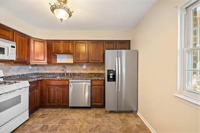 kitchen with a sink, appliances with stainless steel finishes, open shelves, and backsplash