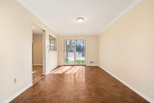 unfurnished room with visible vents, baseboards, and crown molding