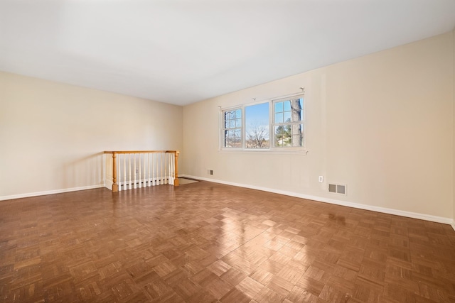 empty room featuring visible vents and baseboards