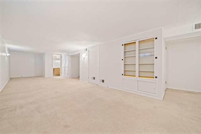 unfurnished room with visible vents and carpet flooring