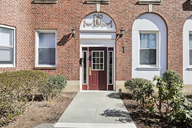 doorway to property with brick siding