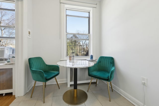 sitting room featuring baseboards and radiator