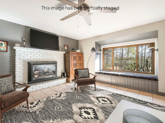 tiled living room featuring a fireplace and ceiling fan