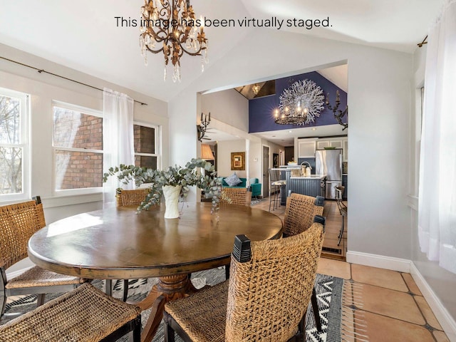 dining space featuring baseboards, high vaulted ceiling, a chandelier, and light tile patterned flooring