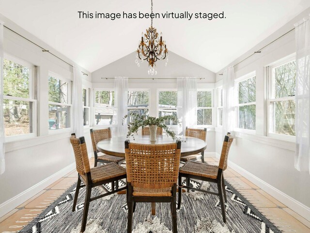 sunroom / solarium featuring plenty of natural light, an inviting chandelier, and vaulted ceiling