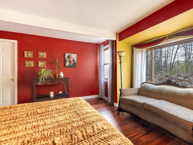 bedroom with baseboards and dark wood-style flooring