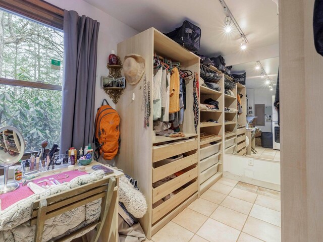 spacious closet featuring light tile patterned flooring