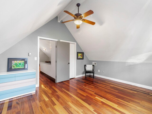 bonus room featuring a ceiling fan, visible vents, wood finished floors, baseboards, and vaulted ceiling with beams