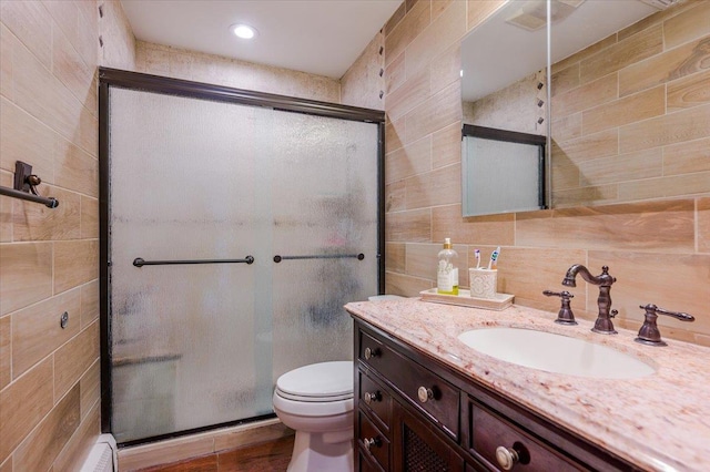 101 Jetmore Pl, Massapequa, NY 11758 - full bathroom featuring vanity, a stall shower, toilet, and tile walls