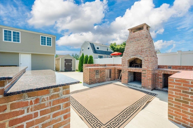 101 Jetmore Pl, Massapequa, NY 11758 - view of patio featuring a storage shed, fence, an outbuilding, and a fireplace