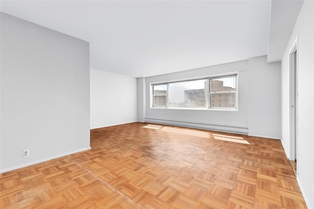 empty room featuring a baseboard radiator and baseboards