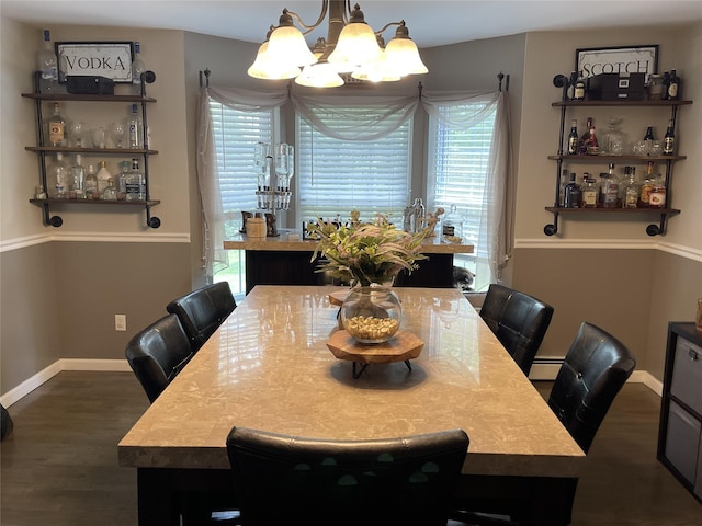 dining room featuring baseboards, a baseboard heating unit, a chandelier, and dark wood finished floors