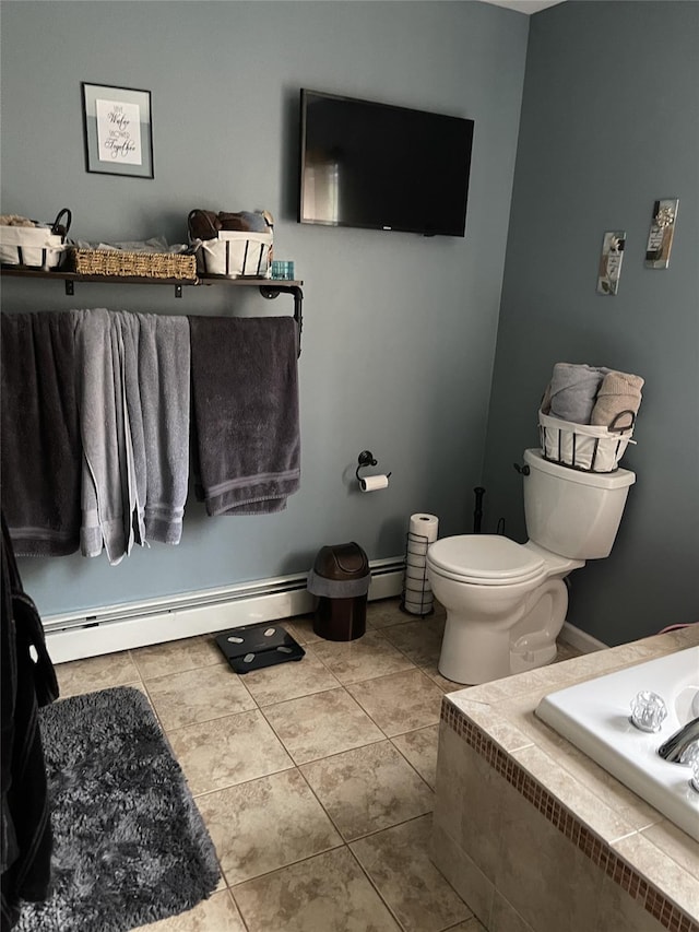 bathroom with baseboards, baseboard heating, toilet, and tile patterned floors