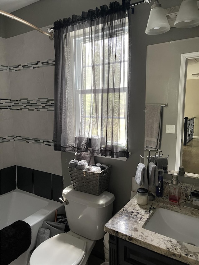 bathroom featuring shower / bathing tub combination, vanity, and toilet