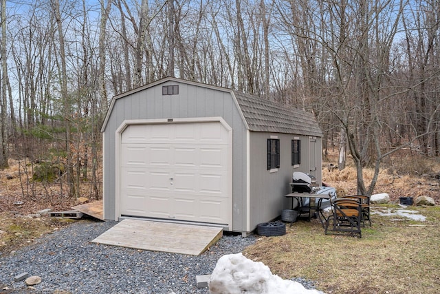 detached garage featuring a shed
