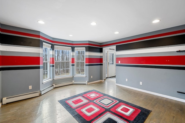 spare room with recessed lighting, baseboards, and wood finished floors