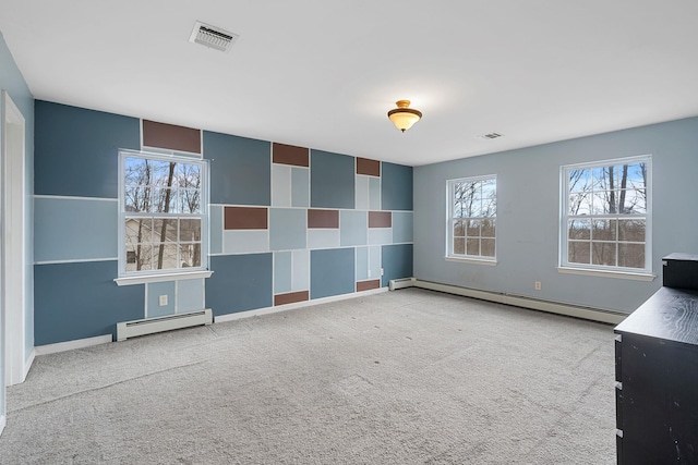 unfurnished room featuring baseboards, visible vents, carpet floors, and a baseboard radiator