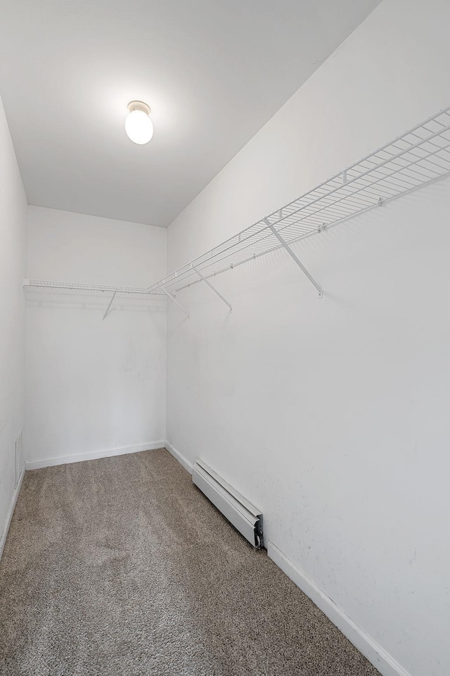 walk in closet featuring carpet floors and baseboard heating