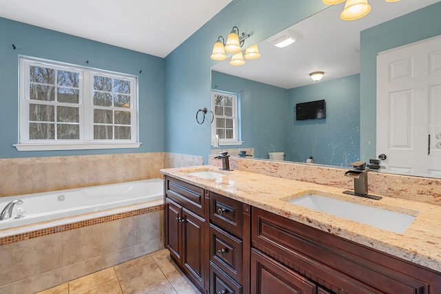 full bath featuring a sink, a garden tub, double vanity, and tile patterned flooring