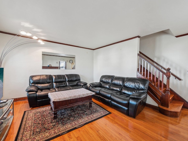 living room with stairway, crown molding, baseboards, and wood-type flooring