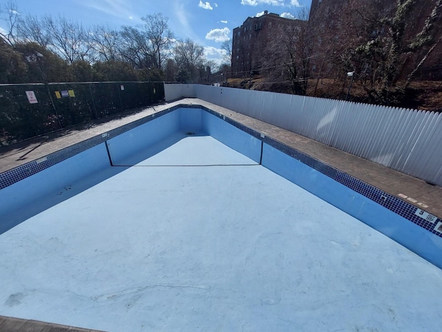 view of swimming pool featuring a fenced backyard and a patio