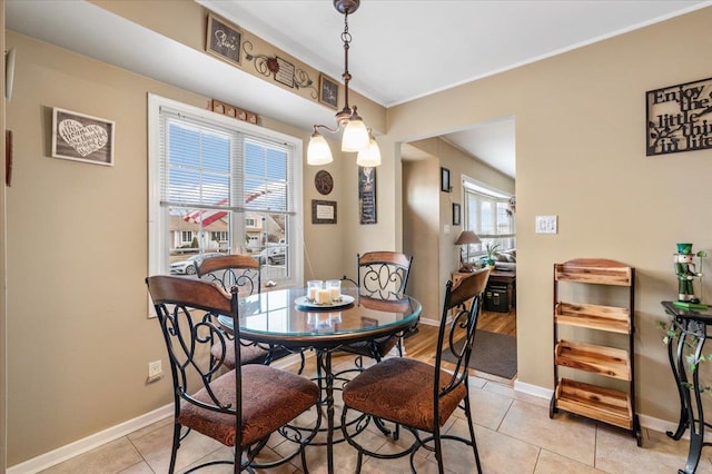 dining space with light tile patterned floors and baseboards